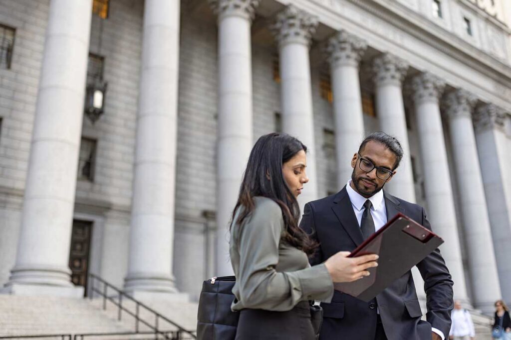 Professionals having a discussion on courthouse steps